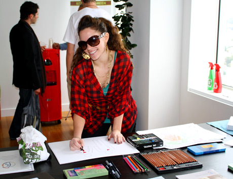 Actress Kimberly Cole decorates and signs art for auction for "Whatever the Need".