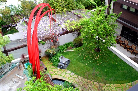 The Courtyard Features Walking Paths and a Koi Pond