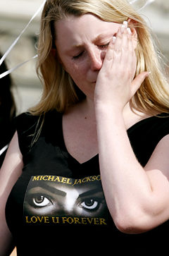 A fan of late pop icon Michael Jackson reacts as she attends a memorial ceremony at the Rathausbruecke bridge in Zurich, Switzerland. Photo courtesy of Wiegmann/Reuters
