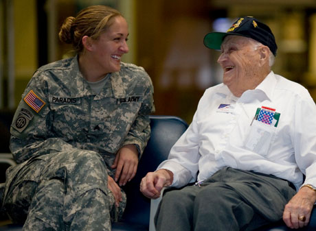 Bill Knight talking with a female soldier at the airport. Bill Knight talking with a female soldier at the airport.
