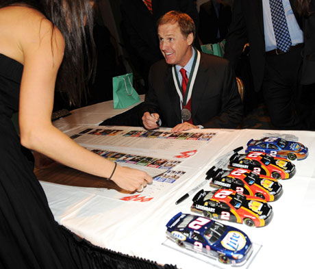 NASCAR past champion Rusty Wallace signs autographs at the cocktail reception at The 24th Annual Great Sports Legends Dinner.