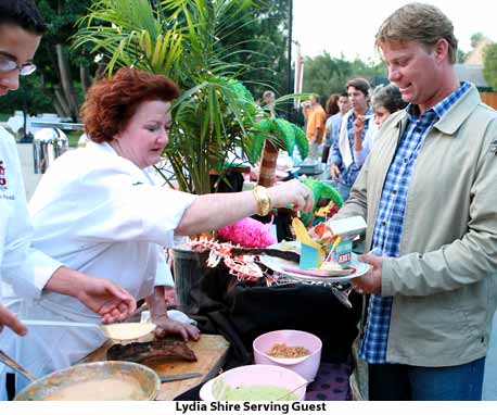 Lydia Shire serves food to guest.