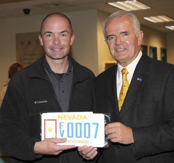 Jeff Evans receiving his gold star license plate from then Governer Gibbons in honor of his dad.
