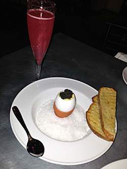 Caviar--Sturgeon fish from Portland, Maine--over scrambled eggs in a shell with country bread...and a blackberry Bellini