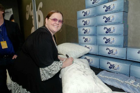 Comedian/actress Melissa McCarthy signing a MyPillow to be auctioned off for charity.
