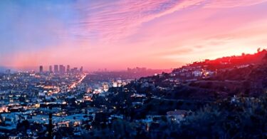Golden hour in Los Angeles, aerial view of the city’s hills, skyscrapers, and houses