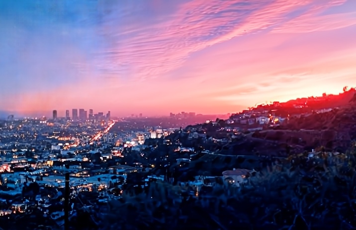 Golden hour in Los Angeles, aerial view of the city’s hills, skyscrapers, and houses
