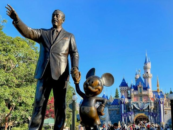 Statue of Walt Disney and Mickey Mouse in front of the Disney castle Statue of Walt Disney and Mickey Mouse in front of the Disney castle