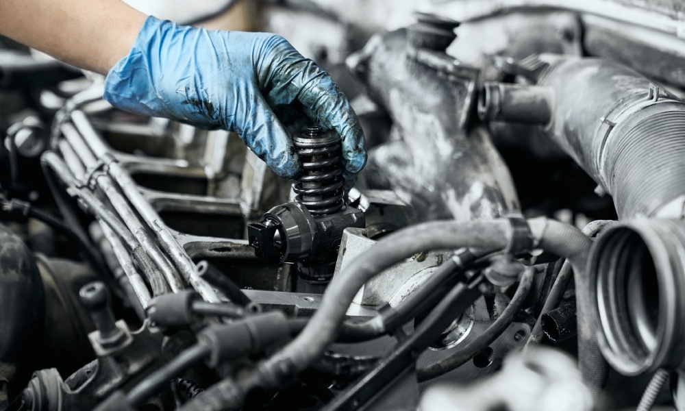 There's a pile of standard silver truck parts sitting against a plain background. There's hubcaps, filters, and more.