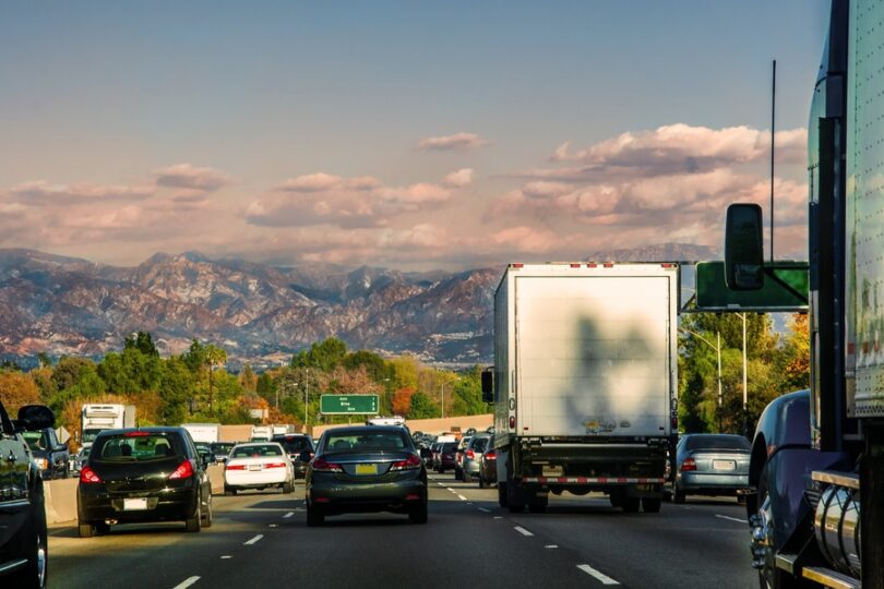 A driver's perspective of traffic in Los Angeles, California with the Transverse Ranges visible in the far distance.
