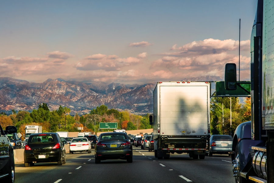 A driver's perspective of traffic in Los Angeles, California with the Transverse Ranges visible in the far distance.