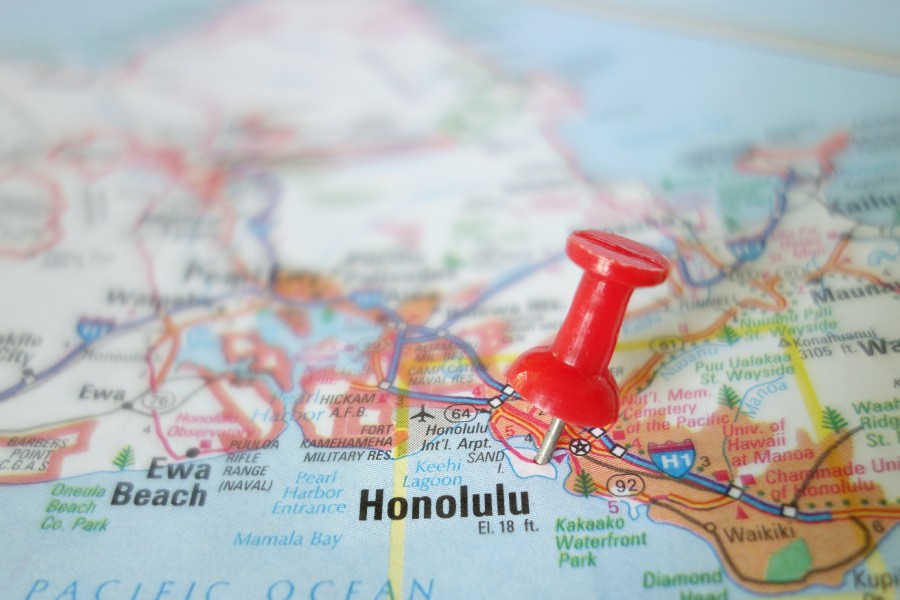 A colorful map zoomed in on Honolulu on the island of Oʻahu, with a red tack marking a location near the airport.
