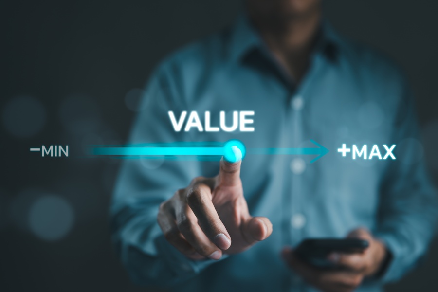 A man holding a calculator moves a point on a virtual progress bar labeled "value" from "min" to "max" with his finger.