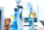 Champagne flutes and drinks arranged on a table at an elegant indoor event.